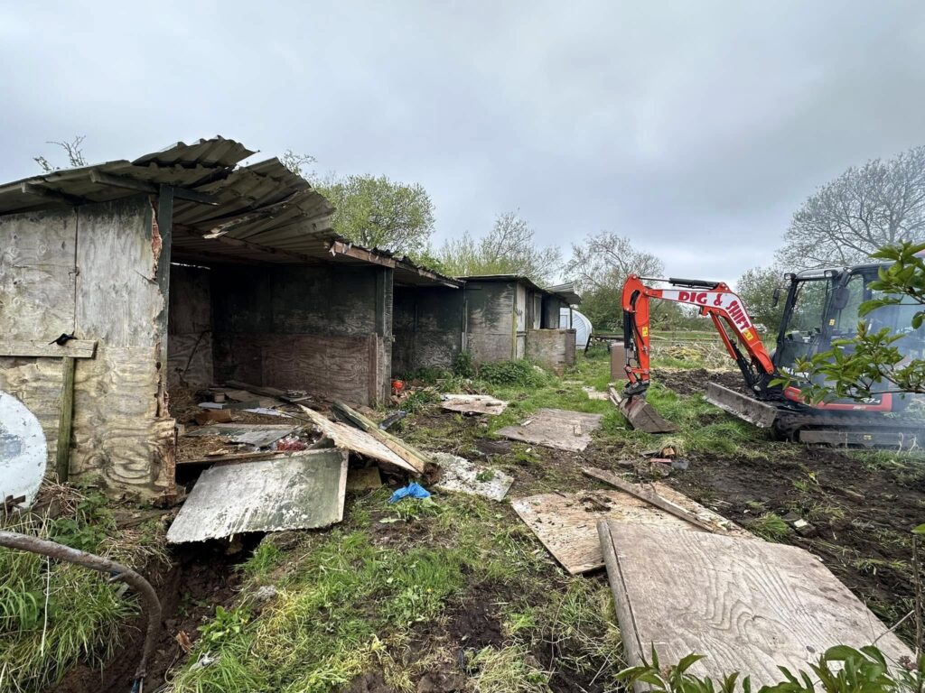 Site Clearance and demolition in Irby, Wirral. Dig and shift removed these old wooden stables to make way for new greenhouses.