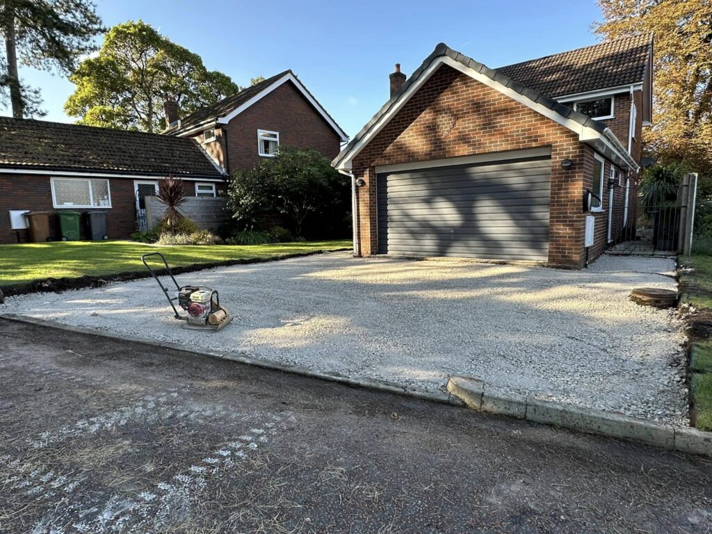 Flattening the MOT stone to level out the are for the new driveway